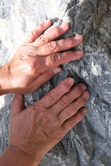 Close Up hand of senior woman on stone background. arthritis, osteoporosis, rheumatism concept.