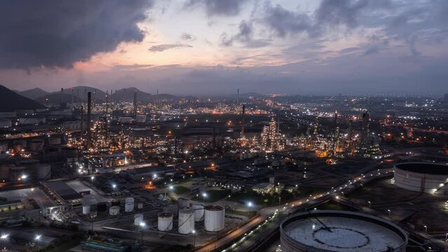 Hyperlapse Timelapse Aerial view night light oil refinery terminal is industrial facility for storage of oil and petrochemical. oil manufacturing products. Motion Time lapse oil refinery. B roll.