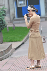 a chinese young girl using a mobile phone