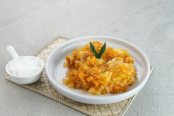Sawut or Gobet Singkong, Indonesian traditional snack made from steamed shredded cassava, and palm sugar, served with grated coconut
