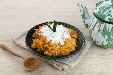 Sawut or Gobet Singkong, Indonesian traditional snack made from steamed shredded cassava, and palm sugar, served with grated coconut
