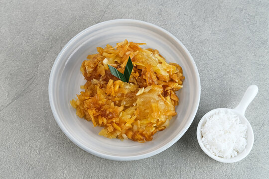 Sawut or Gobet Singkong, Indonesian traditional snack made from steamed shredded cassava, and palm sugar, served with grated coconut
