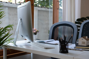 Cropped shot of worktable with mock up two laptop, stationery and supplies in co working space