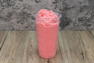 Tasty stawberry blended drink in a tall cup and ice cold for that thirsty appetite