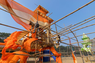 KOLKATA, WEST BENGAL, INDIA - JANUARY 18TH 2015 : Unknown labour dismantling a pandal (a temporary...