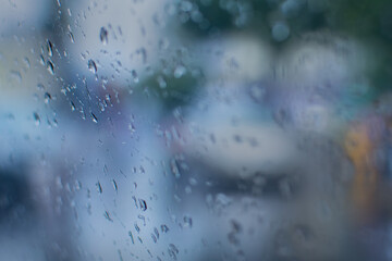 Raindrops falling on glass, abstract blurs - monsoon stock image of Kolkata (formerly Calcutta) city , West Bengal, India
