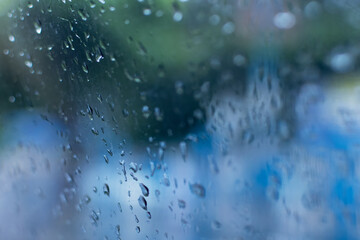 Raindrops falling on glass, abstract blurs - monsoon stock image of Kolkata (formerly Calcutta) city , West Bengal, India