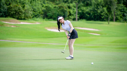 Professional woman golfer teeing golf in golf tournament competition at golf course for winner	
