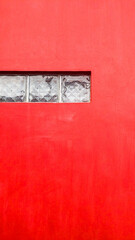 red wall with non-transparent glass box