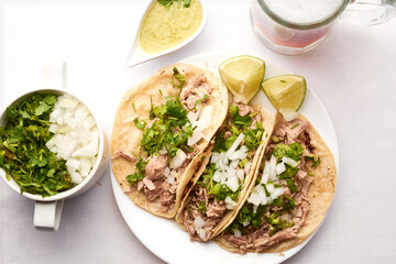 Pork or pork tacos, part that uses the knuckle and corn tortilla, prepared with xalapeño pepper sauce, cilantro and onion