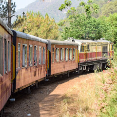 Toy Train moving on mountain slopes, beautiful view, one side mountain, one side valley moving on...