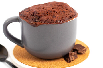 mini cake. Breakfast in a mug. mugcake is microwaved. Homemade cupcake in a mug is on a plate. Chocolate brownie mug cake. Easy cooking concept, microwave baking. muffin chocolate. chocolate biscuit.