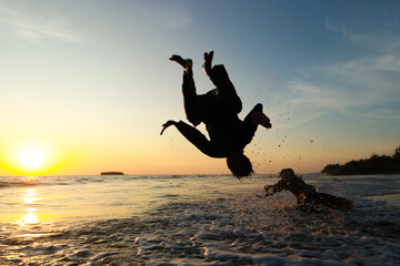 Fototapeta na wymiar person jumping on the beach at sunset