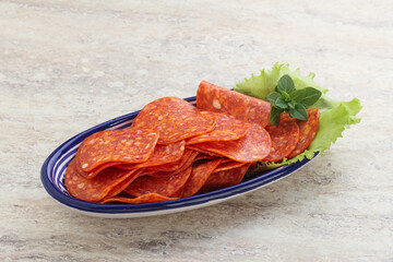 Sliced pepperoni sausage in the bowl