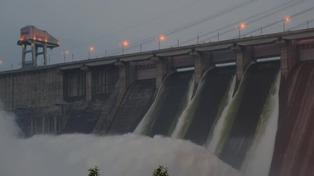 Hydroelectric dam top view. Discharge of water at hydroelectric power plants. Big waterfall. Electricity. Krasnoyarsk hydroelectric power station. Yenisei river.