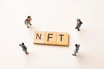 businessman figures at NFT words