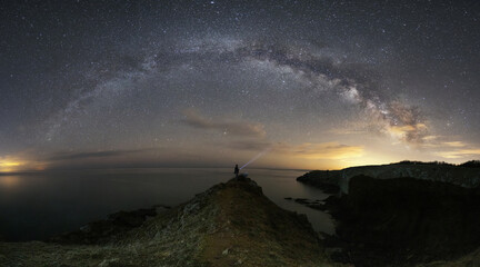 The arc of milky way over black sea.