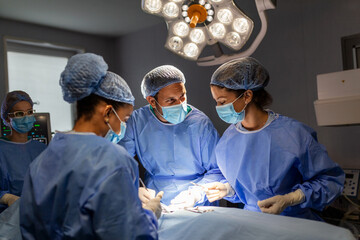 Diverse Team of Professional surgeon, Assistants and Nurses Performing Invasive Surgery on a...