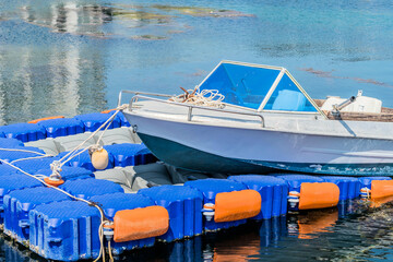 Fototapeta na wymiar Fishing boat moored to floating dock