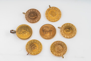 Macro shot of Turkish gold (Quarter ,half or Full gold) on a white background