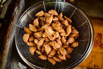 Pansip, an ancient Thai dessert that is freshly fried in a stainless steel wire rack.