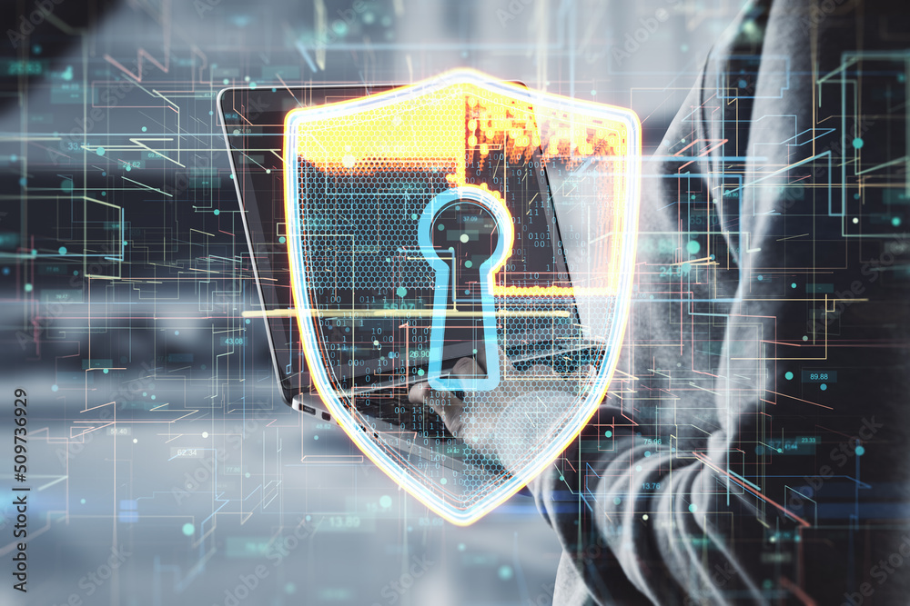 Poster close up of hacker hands using laptop with glowing safety shield hologram on blurry interior backgro