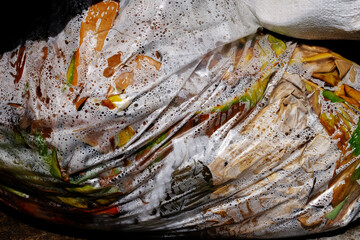 Plastic bags filled with food waste for disposal.