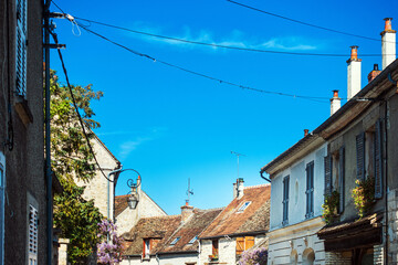 Fototapeta na wymiar Milly-la-Foret, FRANCE - April 16, 2022: Street view of old village Milly-la-Foret in France