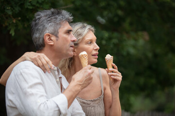 happy couple eating ice-cream outdoor