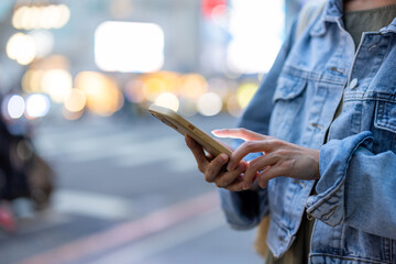 Woman hold with cellphone at street