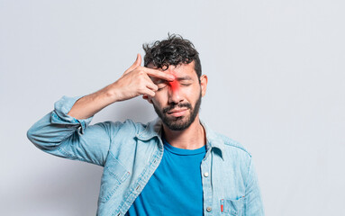 Young man with pain touching nose. A person with nasal bridge pain, Man with nasal bridge headache. Sinus pain concept