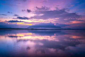 Beautiful sunset or sunrise with dramatic sky clouds over calm sea in tropical Koh Phra Thong island, Phang Nga.  Amazing nature view and light of nature.