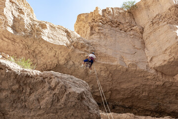 Experienced athlete on Israel Independence Day descending with equipment for rappel in mountains of...