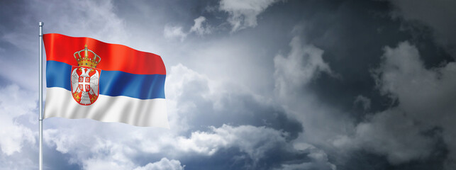 Serbian flag on a cloudy sky