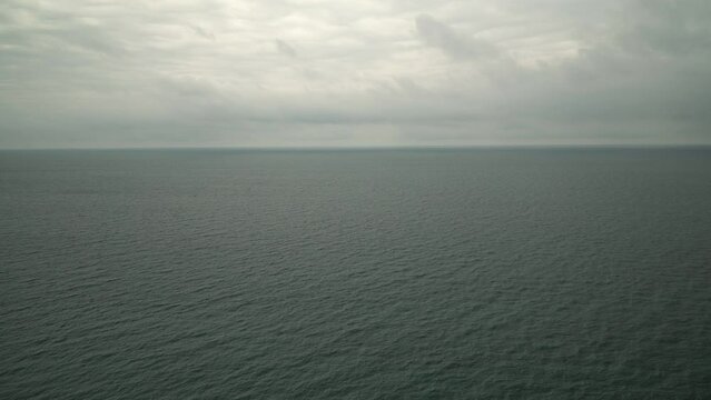 Cold calm sea or ocean on a cloudy day. Sea background in winter before a storm