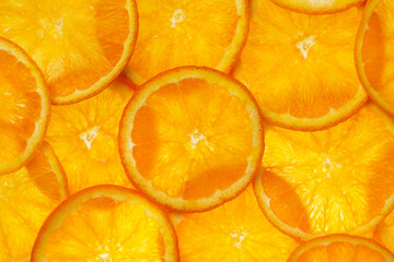 Many orange round slices top view. Orange citrus fruits background.