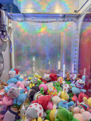 colorful dolls inside the claw game machine