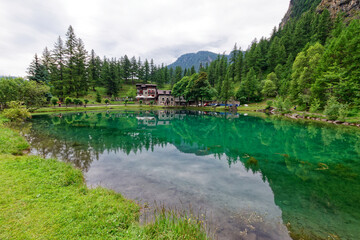Fototapeta na wymiar View of Laux lake, small alpine lake near Usseaux, in Val Chisone, Piedmont, Italy