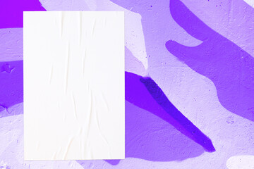 Closeup of colorful purple, violet, lilac painted urban wall texture with wrinkled glued poster template. Modern mockup for design presentation. Creative urban city background. 