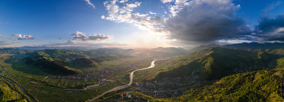 Aerial drone view of a valley with town in Maramures, Romania