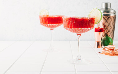 Strawberry Margarita or Daiquiri Cocktail with lime and mint on white background.