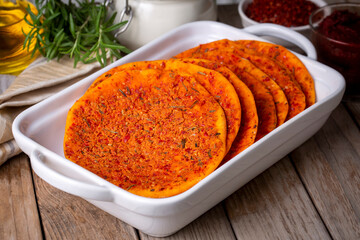 Traditional Turkish Biberli Ekmek “Flat bread with red pepper paste” being prepared before cooking in Antakya Hatay, Turkey (Antakya katik)