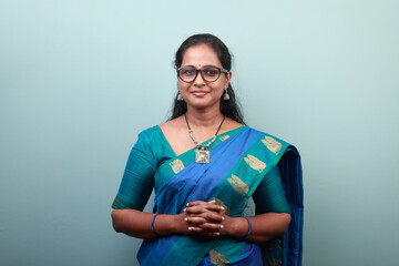 Portrait of a happy woman of Indian ethnicity wearing traditional dress sari - obrazy, fototapety, plakaty