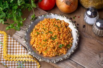 Traditional turkish bulgur pilaf with tomato sause in plate (Turkish name; meyhane pilavi)