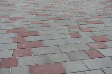 Sidewalk pavement made of simple pink and grey concrete blocks
