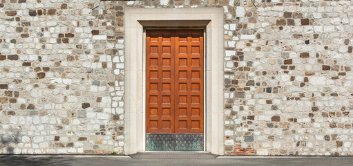 Panorama - Großes altes Tor aus Holz einer Kirche mit Steinmauer Fassade. Steinmauer mit...