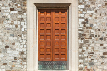 Eine große alte dekorierte Tür aus Holz in einem Haus aus Stein gebaut. A large old decorated...