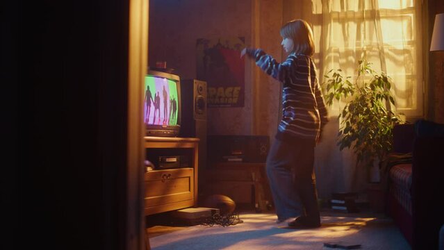 Nostalgic Retro Childhood Concept. Young Girl Dancing to Music Video on TV Channel in Her Room with Dated Interior. Excited Kid Repeat Dance Moves Dancers Perform in the Clip.