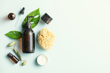 Natural skin care products on blue background, flat lay.