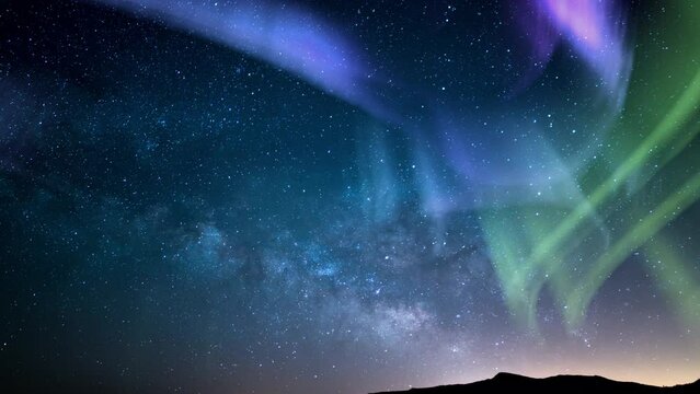 Aurora Green Purple and Milky Way Galaxy Over Horizon Tilt Up